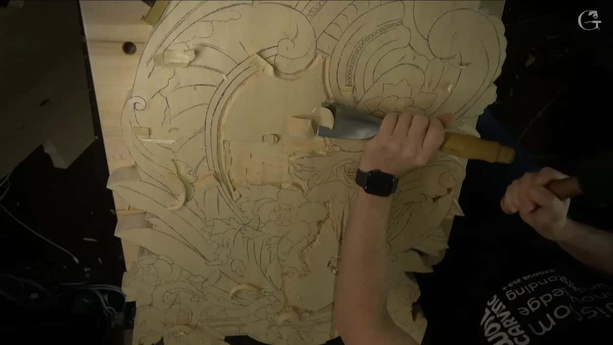 Overhead, the huge #7 set against the field while the other hand holds a mallet ready.