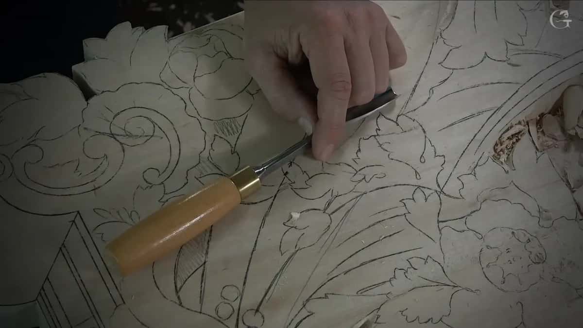 Gouge with a brass ferrule held over a pencil leaf