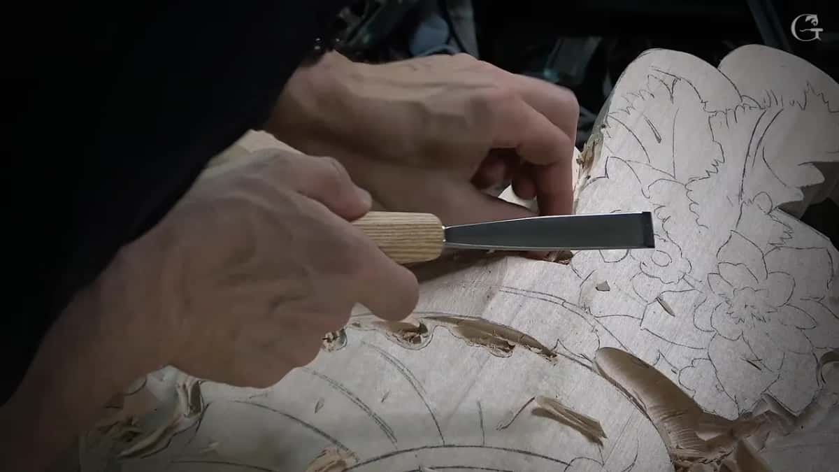 Small flat gouge near a drawn flower, pale handle