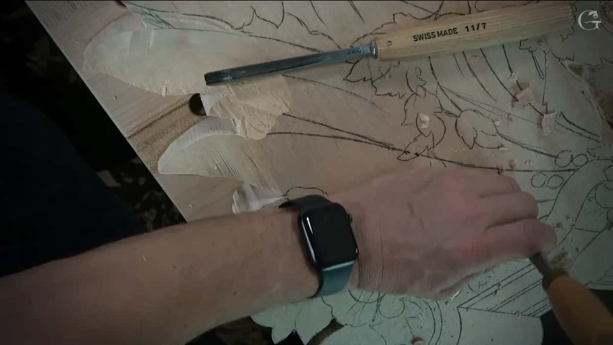Number 11 stamped 11/7 lying across the pencil lines while the other hand keeps working