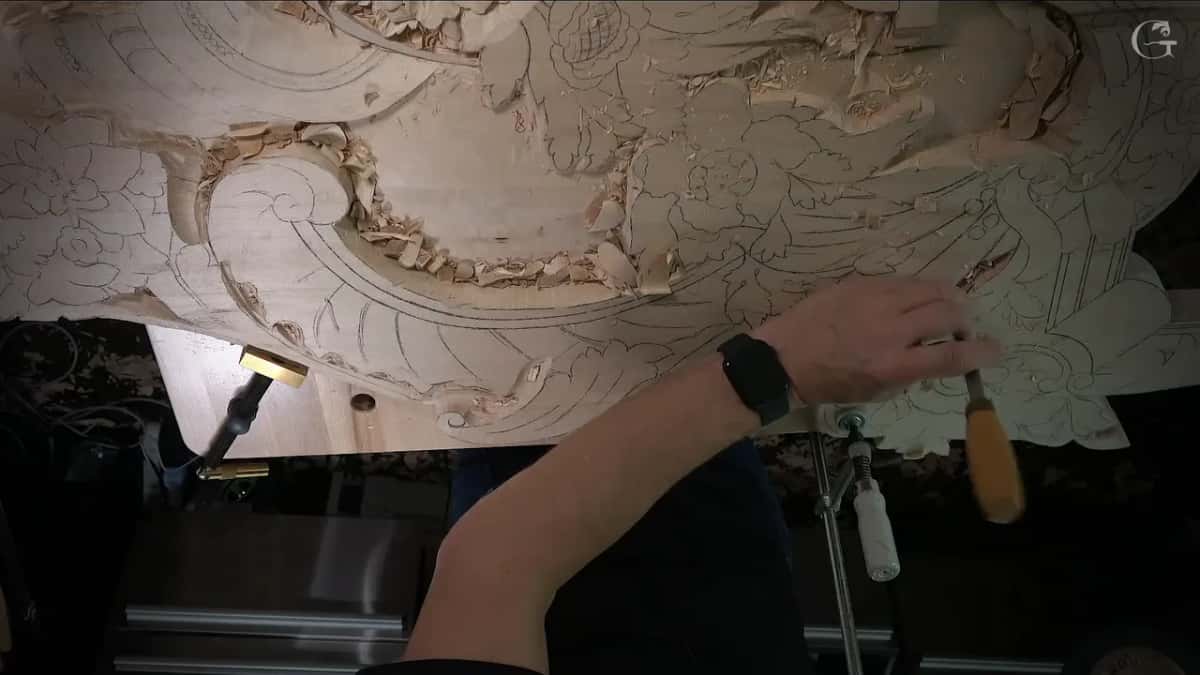 Hand with a tool beside the clamp