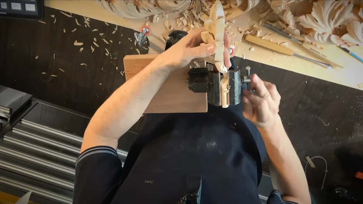 Only a guess Carved layer standing in the clamp jaws while both hands set it straight