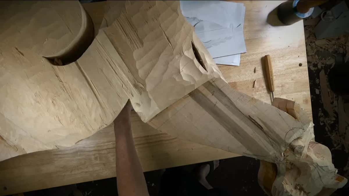 Roughed down Roughed down to the shape, an arm laid across it, drawings and one gouge to the side
