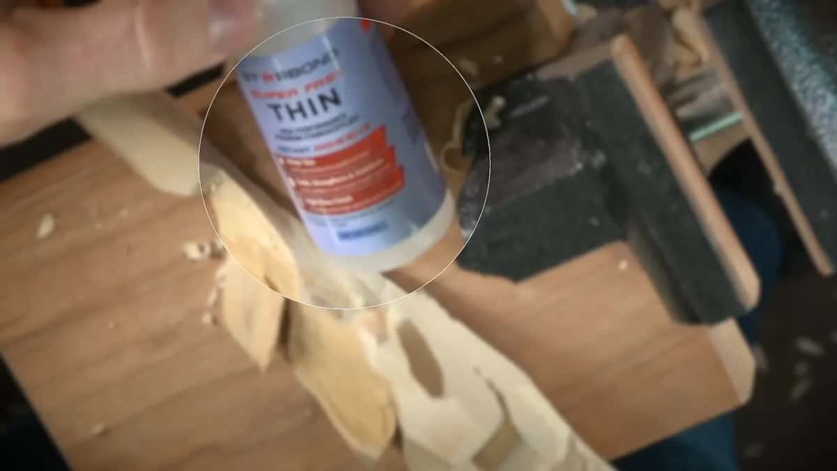 Thin Glue bottle magnified in a round overlay so the word THIN can be read