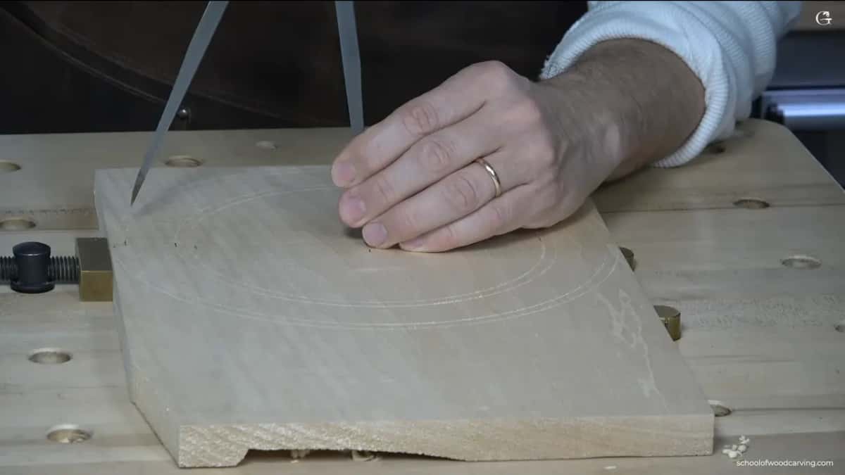 One hand pins the board while the calipers work near its edge.