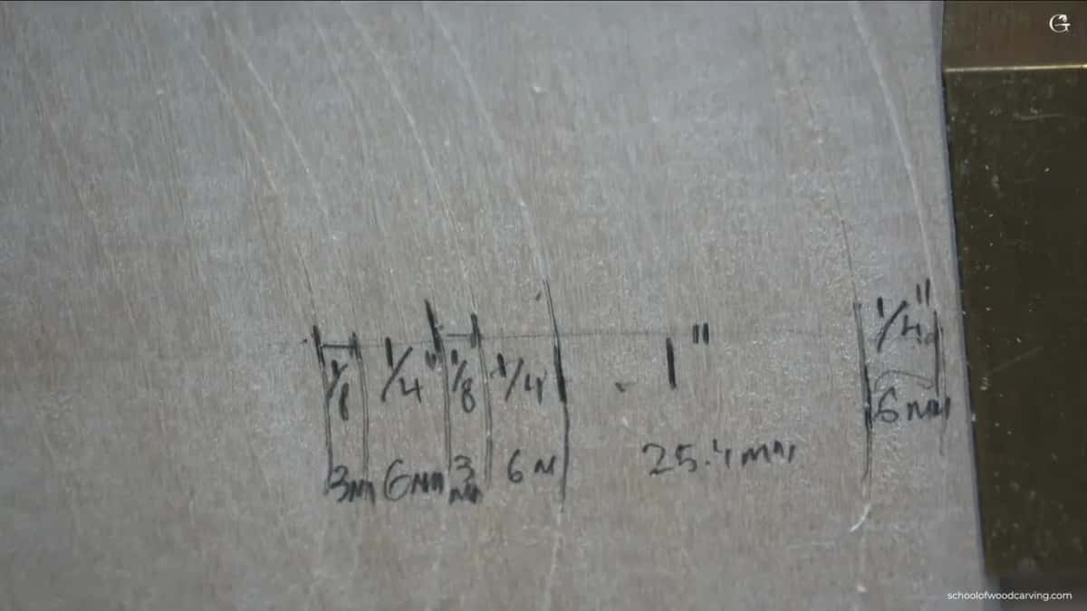 Ring widths penciled right on the basswood, fractions of an inch above and millimeters below them.
