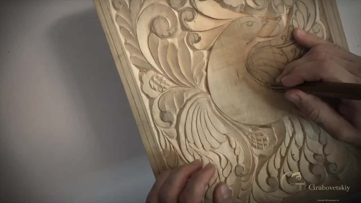 Both hands steady the panel while the blade goes barely into the surface.