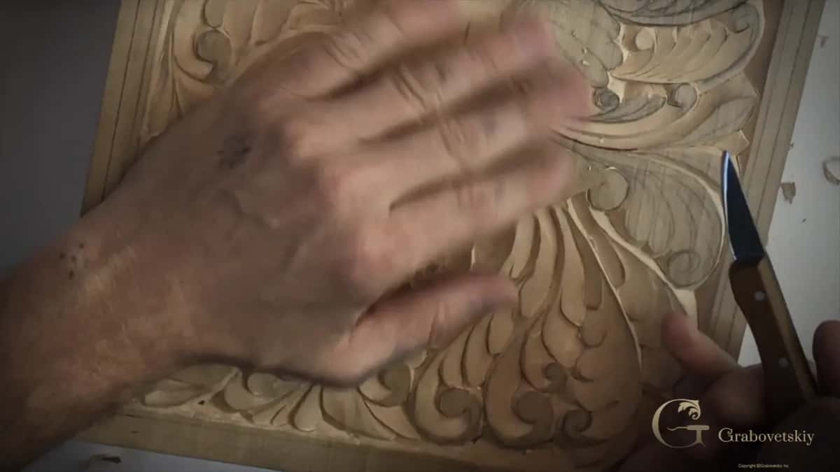 Fingers reading a carved surface that will never meet sandpaper.