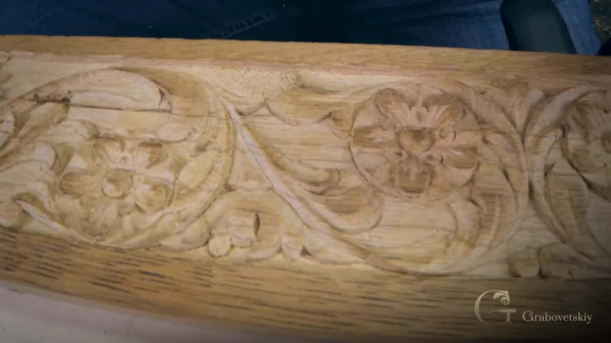 Carved furniture rail with rosettes and leaves, and the stippled punched ground sitting just behind them