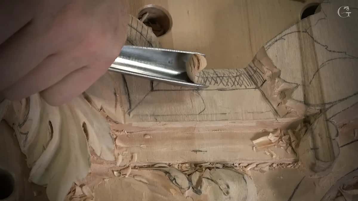 Wide gouge lifts a curl of wood off the hatched section