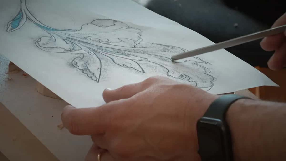 On the paper drawing, a thin veiner points to one line