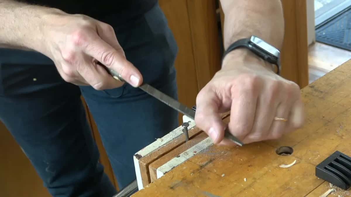 File tipped at an angle over the nail