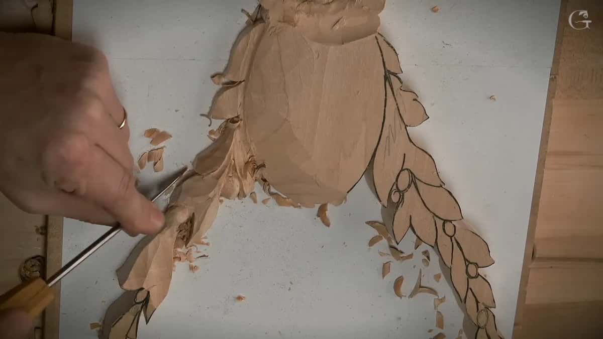 Long thin blade with a light handle laid flat along the lowest leaves of the left spray