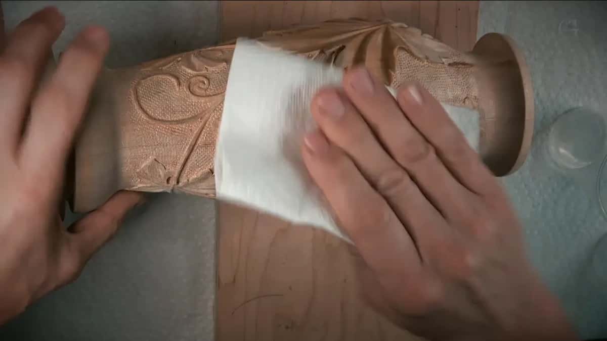 Paper towel pressed flat on the carving by two hands before any stain goes on