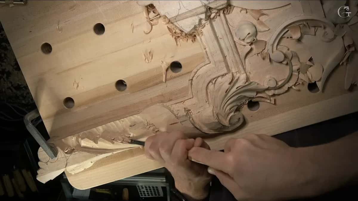 Right hand pushing a gouge down the band