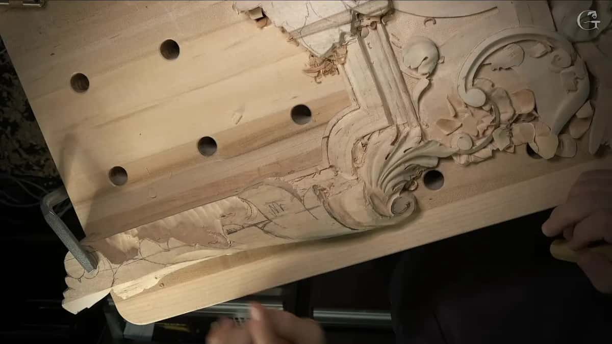 The whole lower band from above, with round holes in the bench top and pencil lines still on the wood