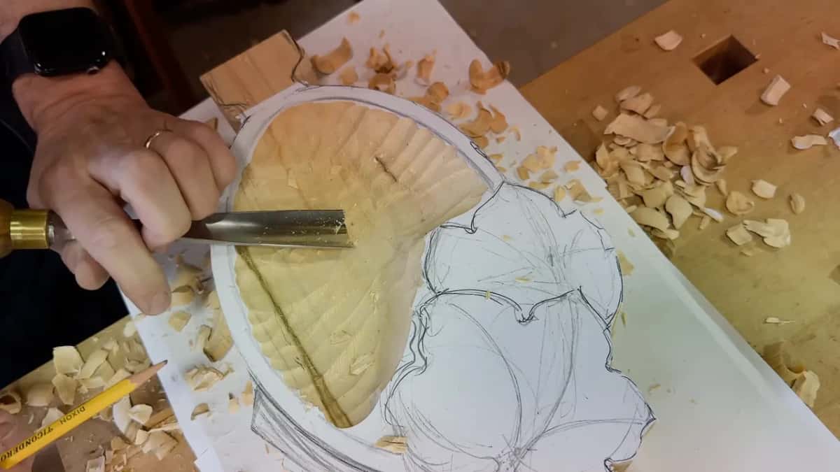 Gouge laid flat across the hollow, a pencil lying on the paper below