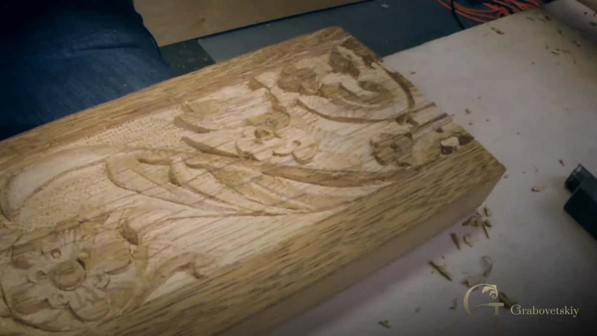 Carved end, chips on the bench