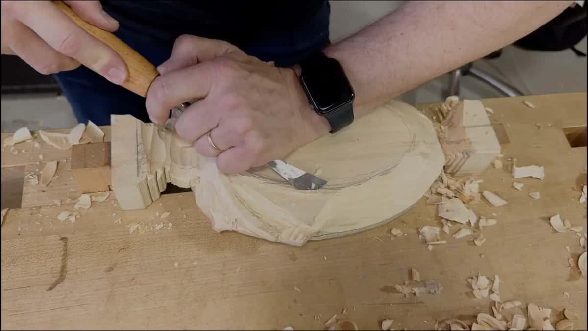 Both hands on a long tool near the end block