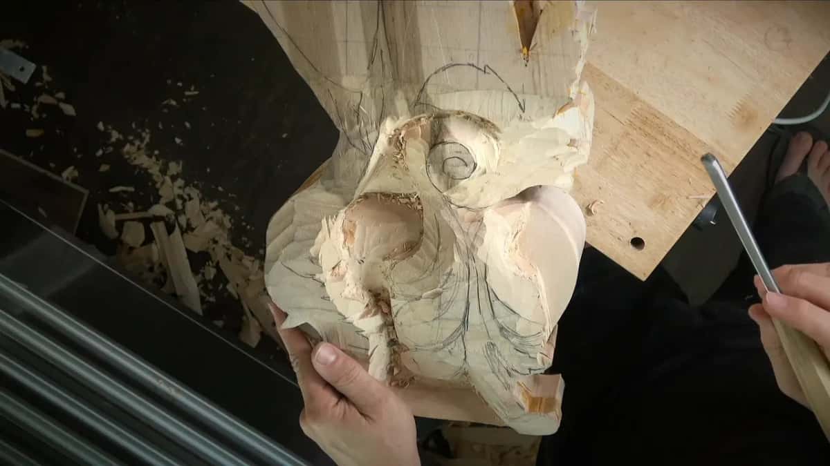A carved block steadied on plywood