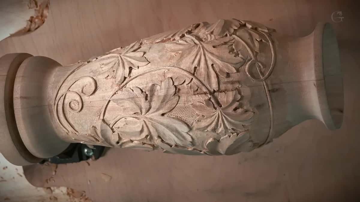 The carved vase with grape leaves, seen from the side.