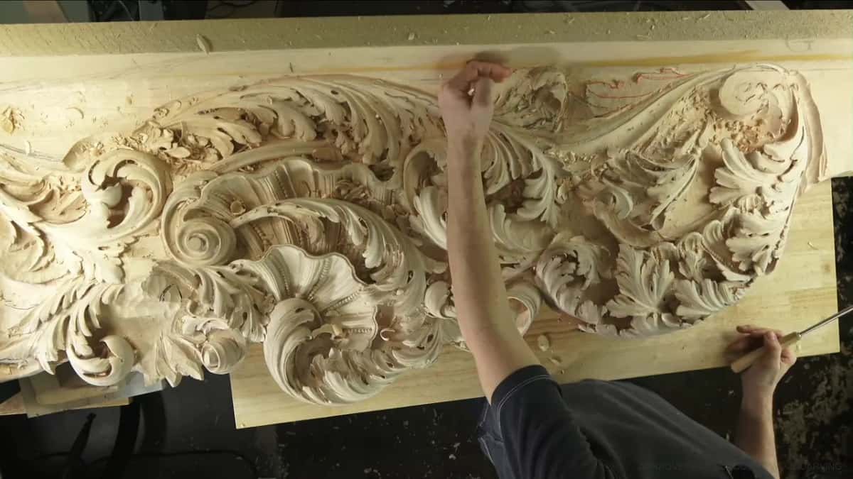 One hand up at the top edge, the other low on the right with a tool