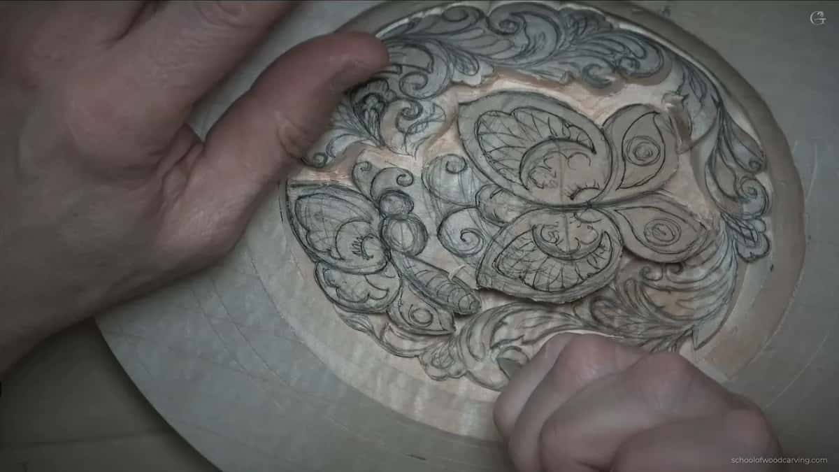 One hand spread over carved butterflies.