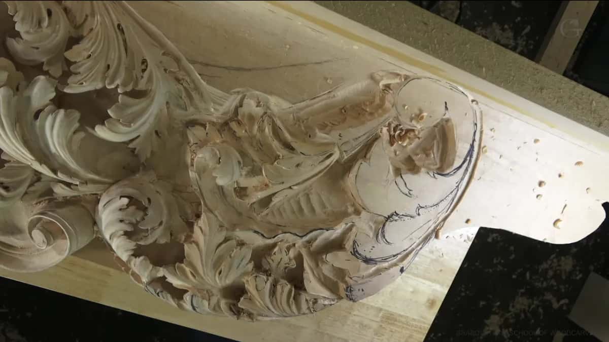 Acanthus scrolls carved deep along a long blank, with pencil lines still on its plain end