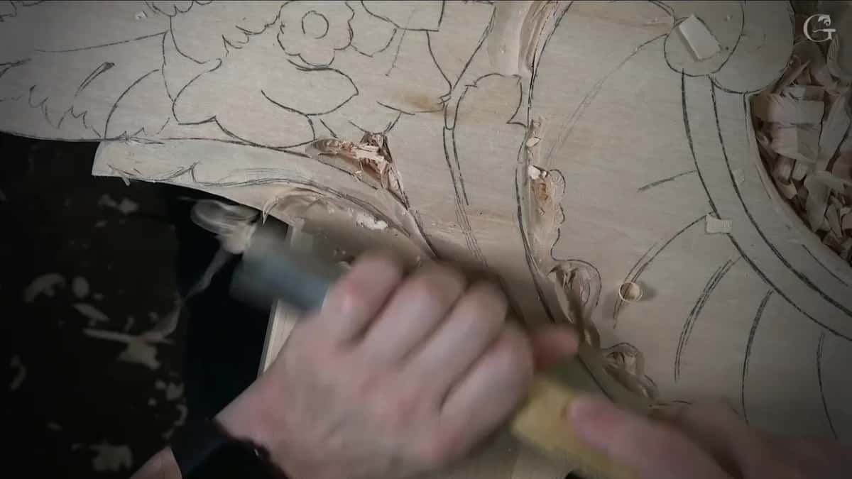 Gouge pushed along a carved curve below pencil flowers