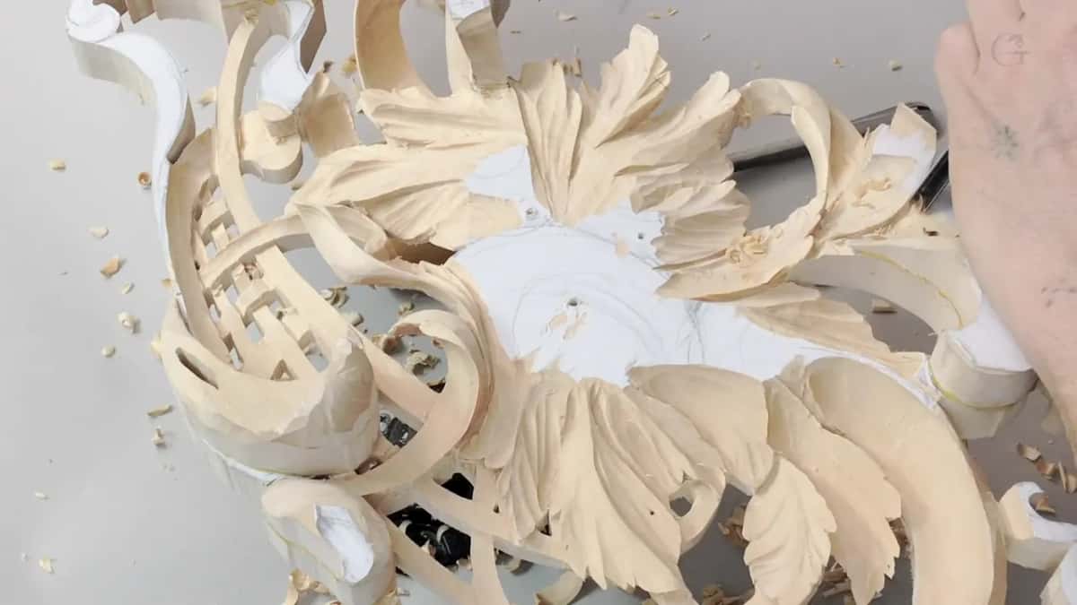 Carved leaves ring a white paper centre.