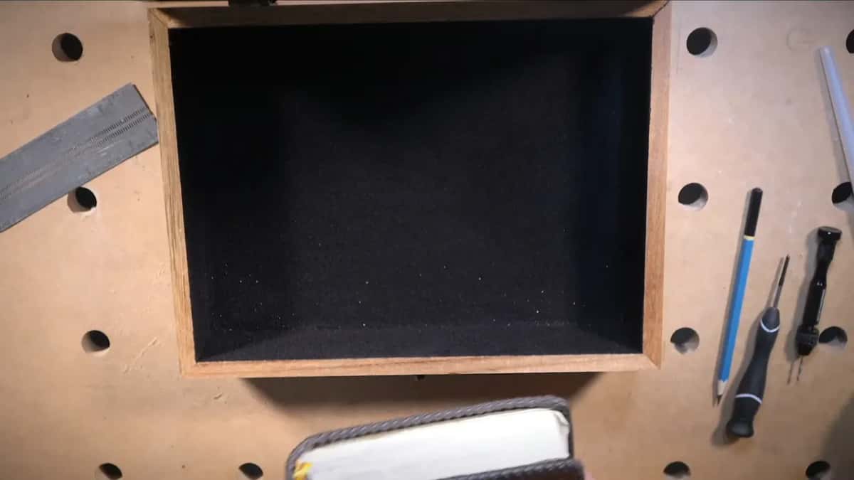 Black flocking lines the empty box