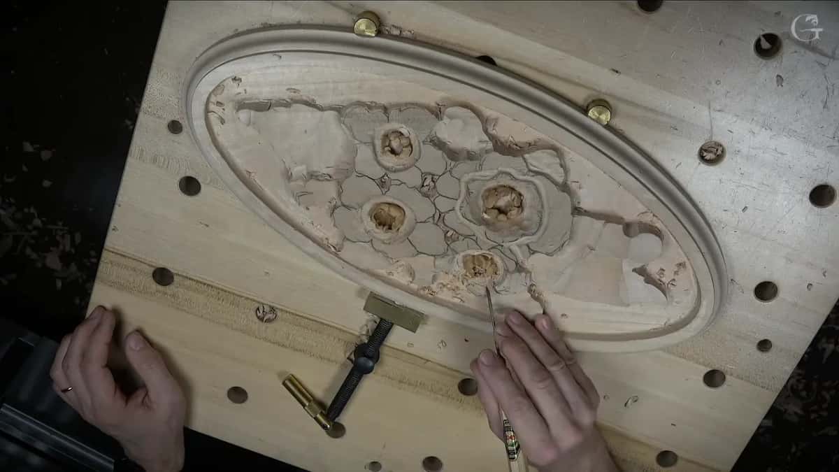 The whole oval from above, with hands and a tool at its lower edge