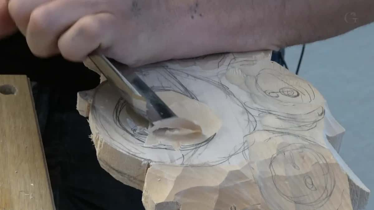 Gouge lifting a curl from a round block marked with pencil circles