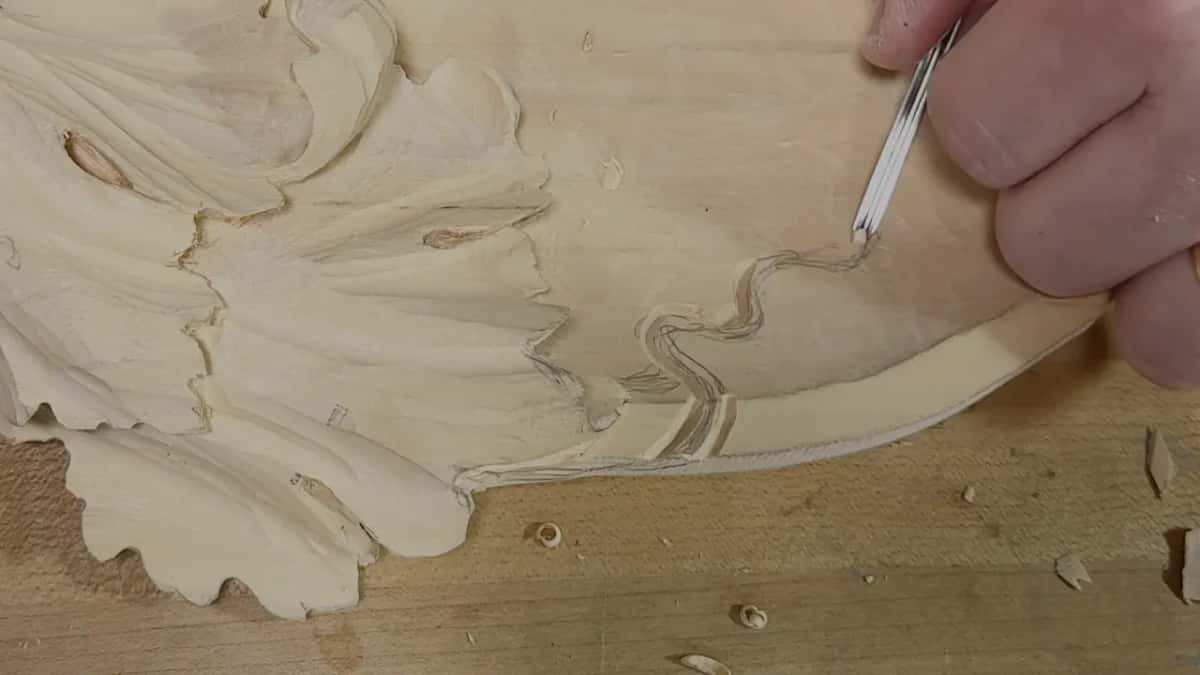 Narrow steel tool above the outlined curl