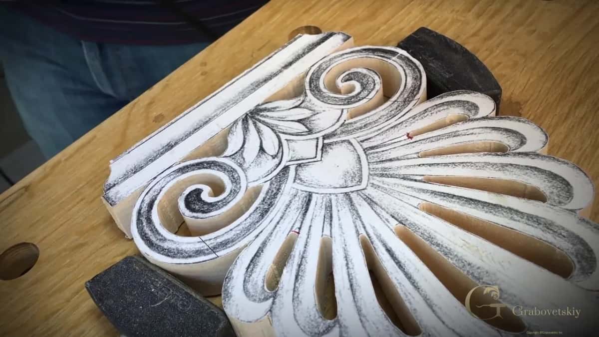 Paper pattern of the whole acroterion glued on the sawn block, which rests between two dark bench stops