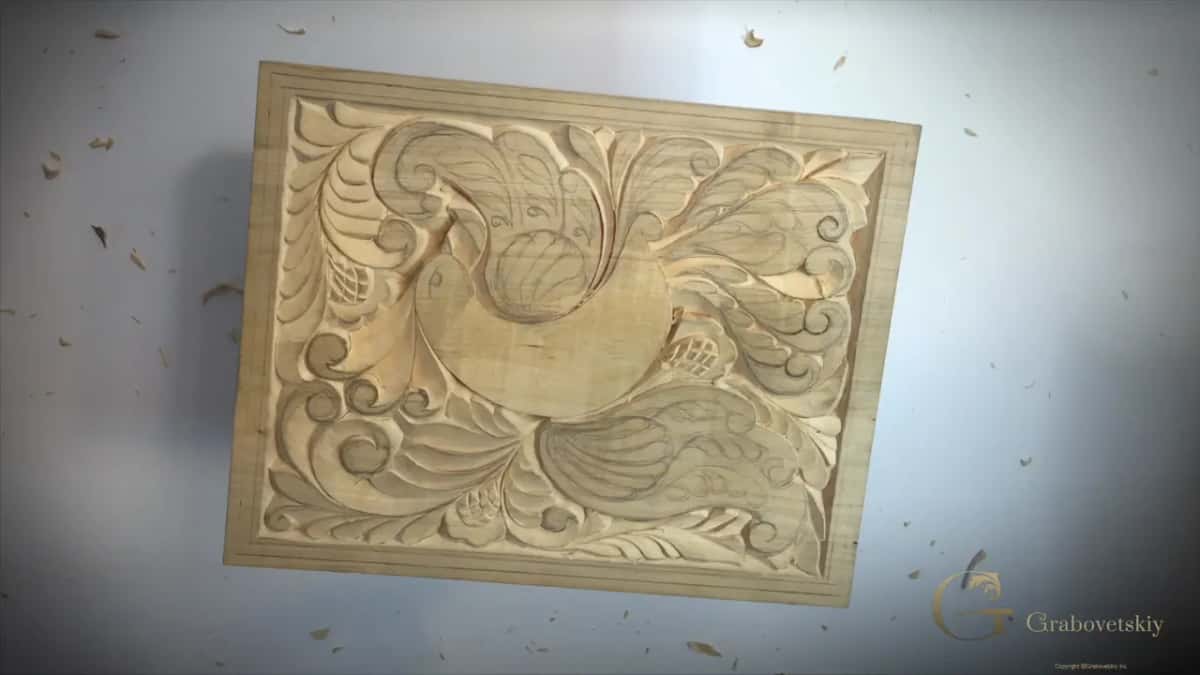 Almost the whole board carved, seen from above, chips scattered around it on the white bench top