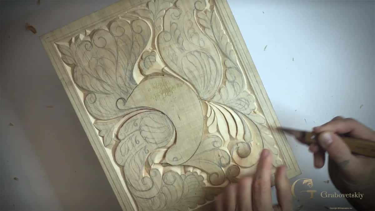 Board turned on the bench with most curls already carved