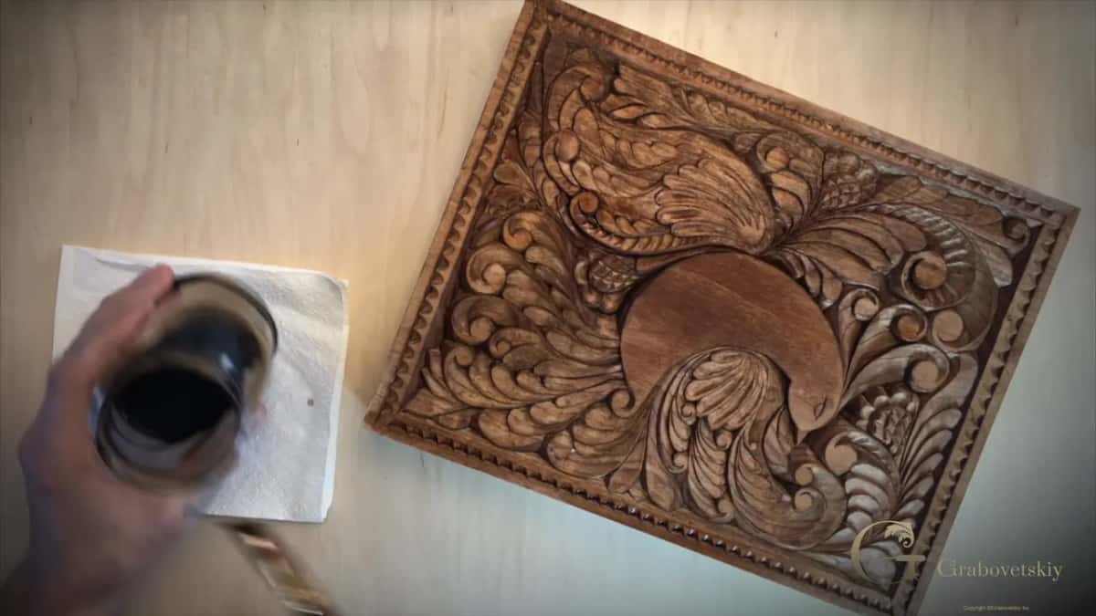 Walnut stained board beside a jar resting on a napkin