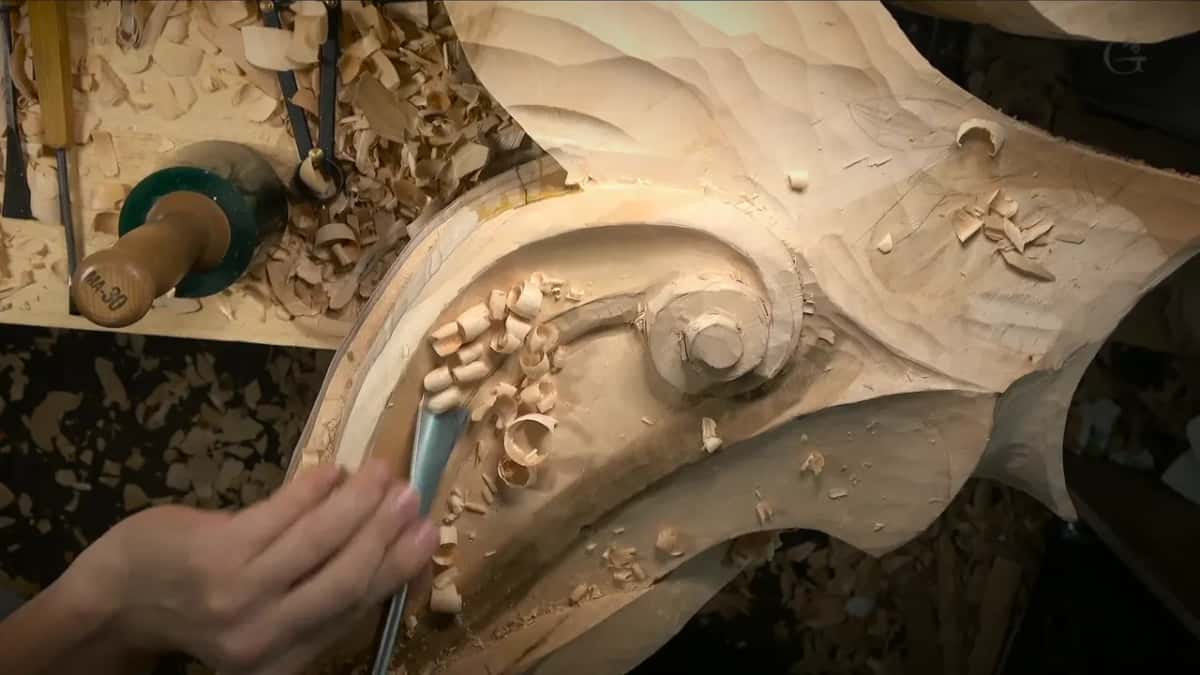 Fingertips guide a narrow gouge