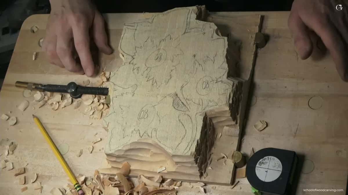 Hands rest on either side of the roughed panel near a tape measure and a pencil