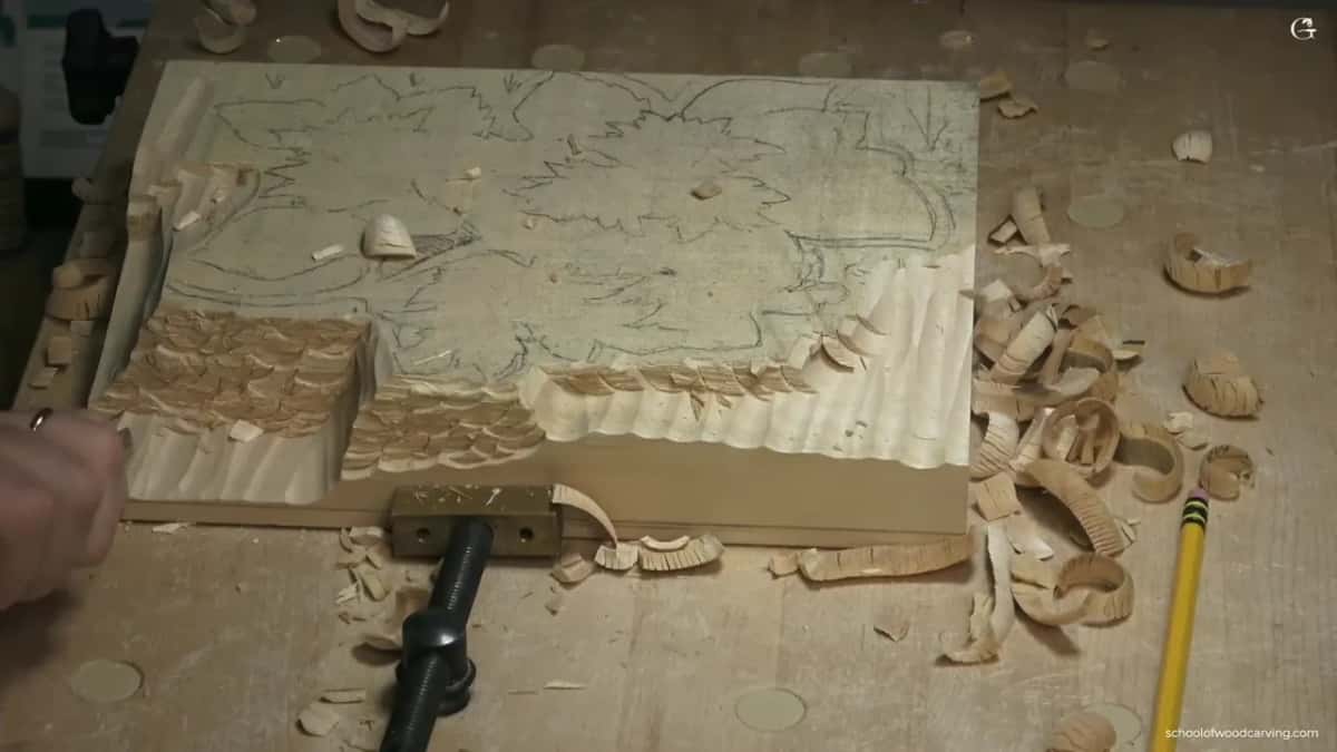 Waste stepped down along one side, basswood curls piled at the right