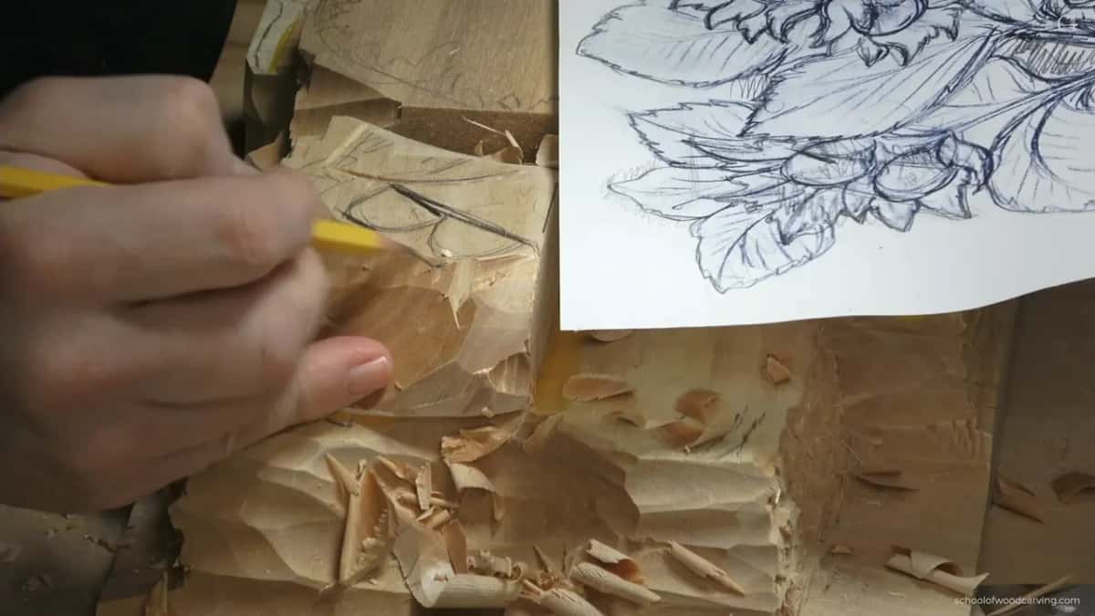 Yellow pencil marking a fresh line on top, with the paper pattern lying alongside