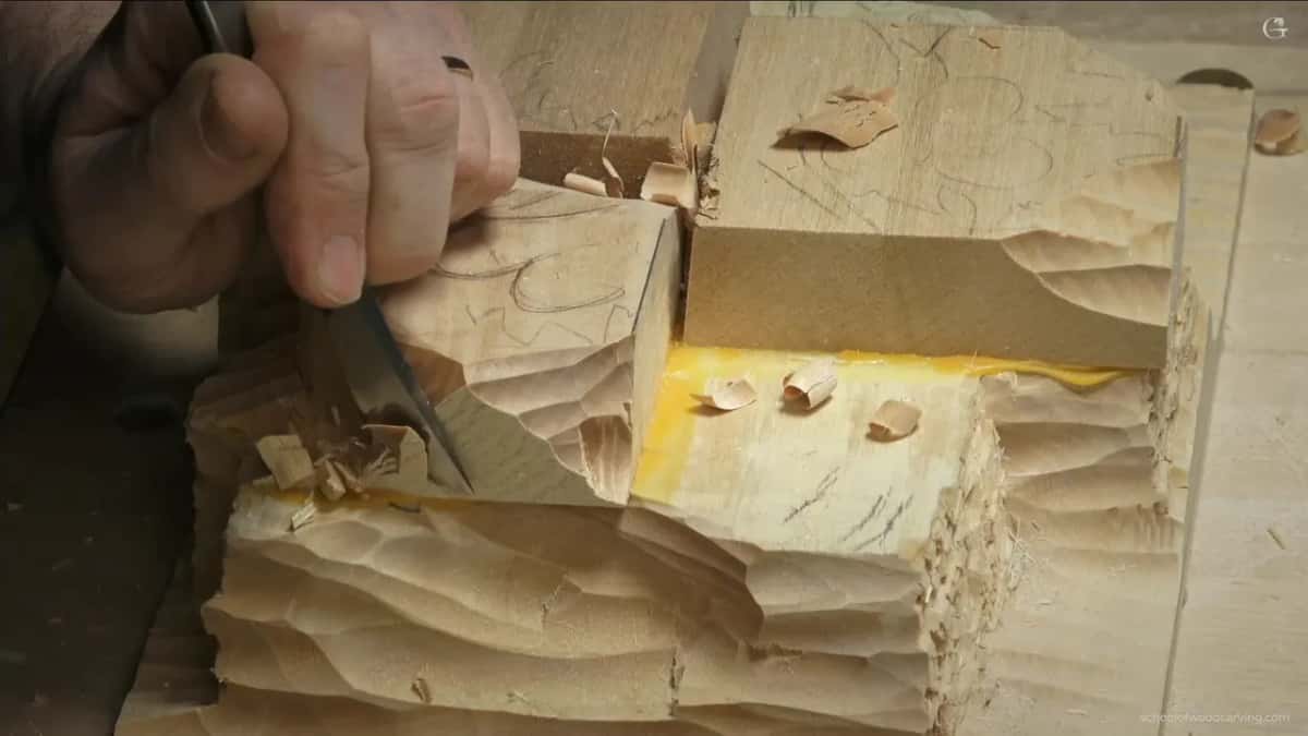 Thumb on the blade, slicing down the side below the drawing