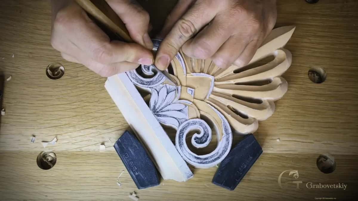 Two hands steer a knife into the center while the small palmette waits in pencil right beside the base