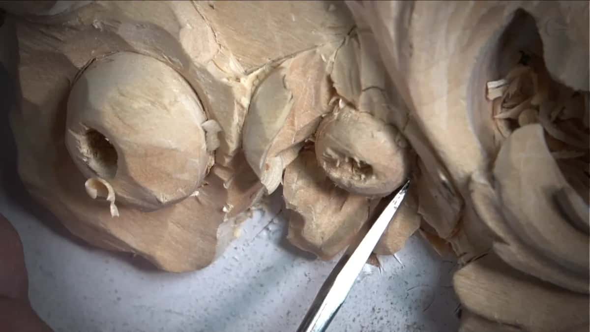 Knife point beside a carved berry