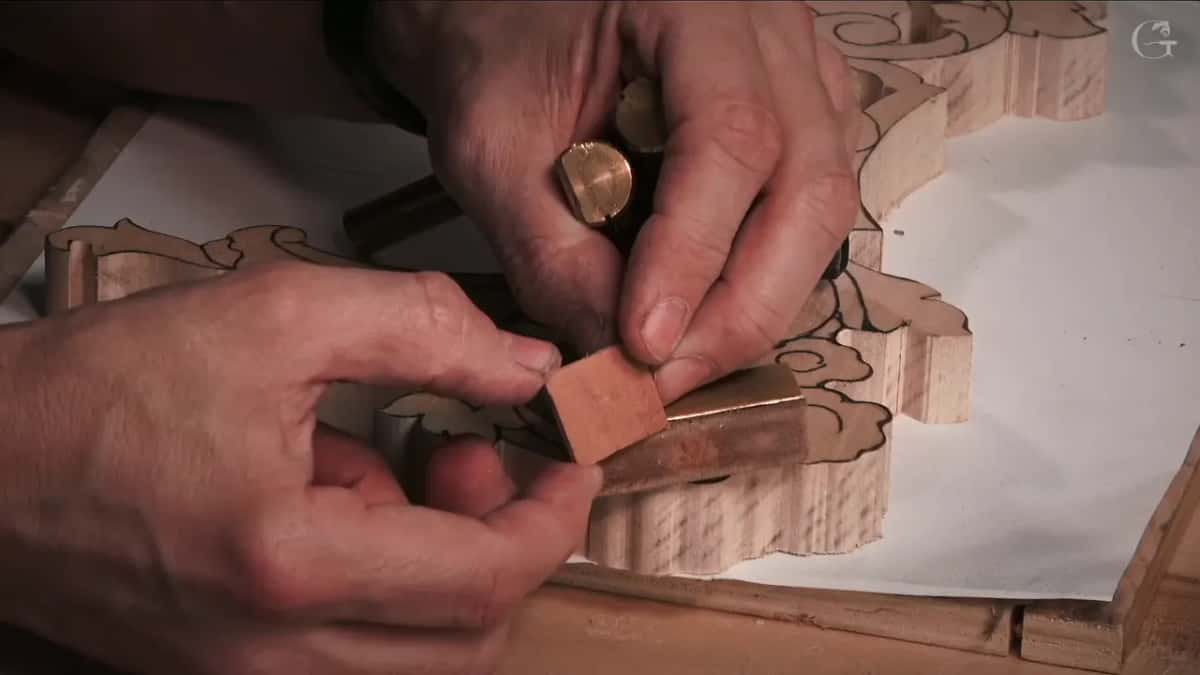 Leather square pressed onto a brass peg