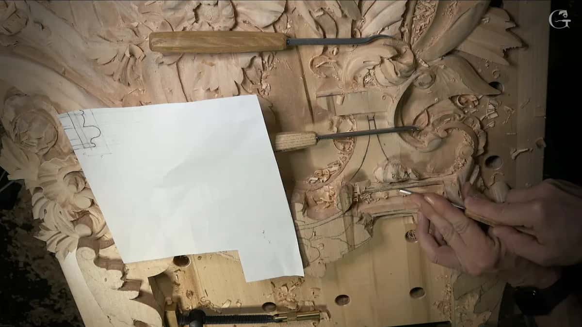 Paper with a small profile sketch in one corner, lying on the panel