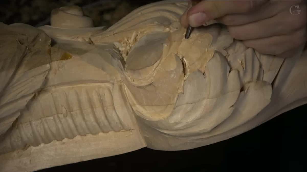Working a small tool along a carved leaf