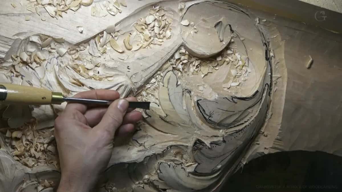A gouge works a scroll