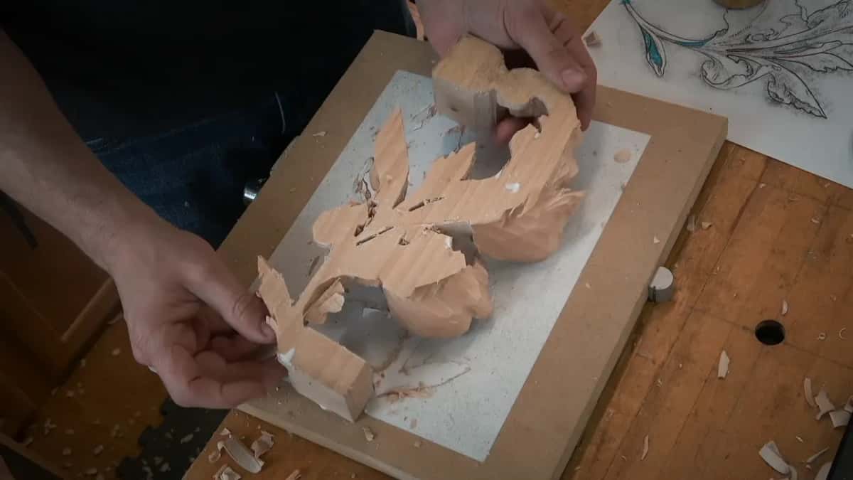 Off the board, the leaf turns over in two hands to show its flat back